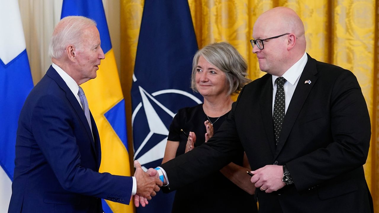 President Joe Biden shakes hands with Mikko Hautala, Finland's ambassador to the U.S., as he speaks with Hautala and Karin Olofsdotter, Sweden's ambassador to the U.S.,after signing the Instruments of Ratification for the Accession Protocols to the North Atlantic Treaty for the Republic of Finland and Kingdom of Sweden in the East Room of the White House in Washington, Tuesday, Aug. 9, 2022. The document is a treaty in support of Sweden and Finland joining NATO. (AP Photo/Susan Walsh)