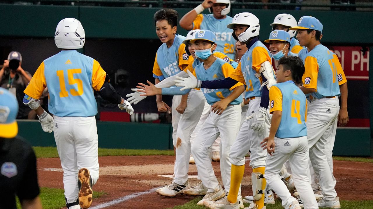 Honolulu Little League's leadoff hitter, Kekoa Payanal, was greeted at home plate in the fourth inning upon his second home run of the day against Massapequa of New York in the Little League World Series U.S. bracket quarterfinals.