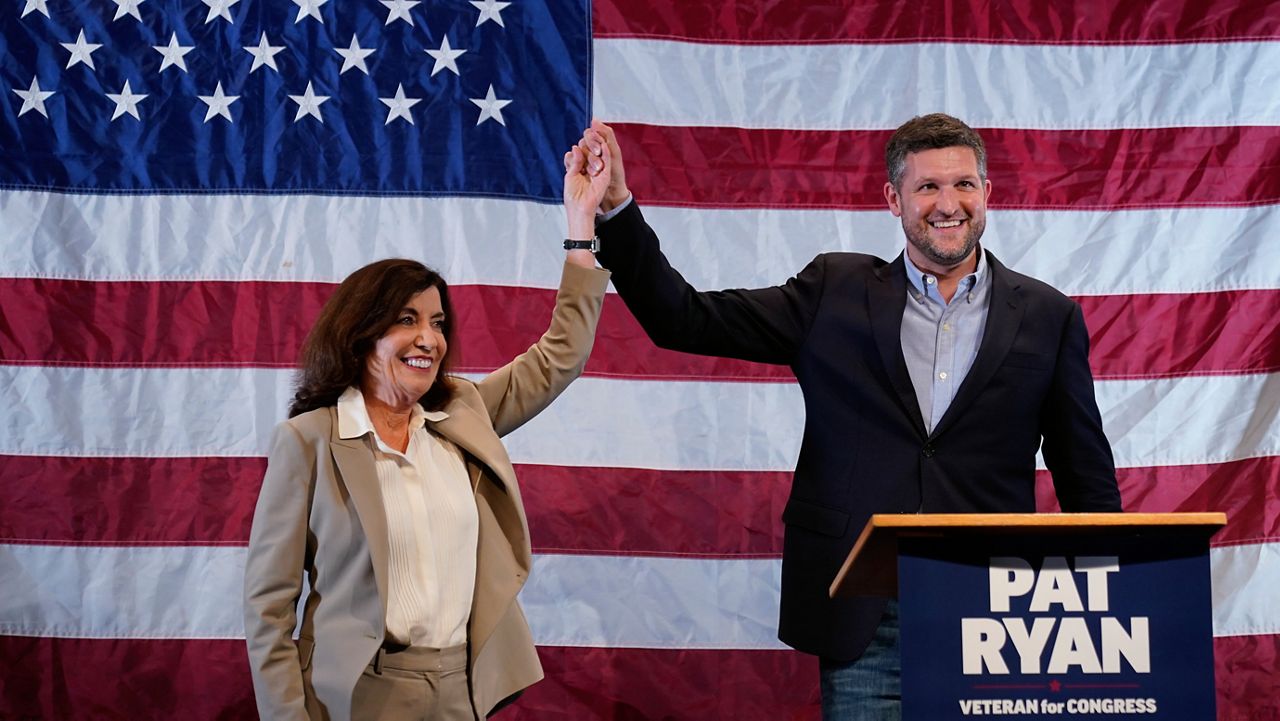 Democratic candidate Pat Ryan, right, and New York Gov. Kathy Hochul appear on stage together during a campaign rally for Ryan, Monday, Aug. 22, 2022, in Kingston, N.Y. (AP Photo/Mary Altaffer)