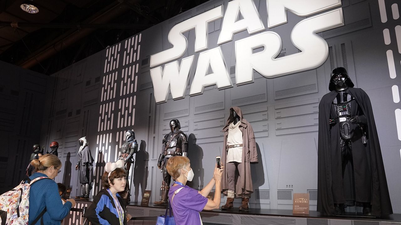 Fans look at Star Wars costumes at the D23 Expo Saturday, Sept. 10, 2022, in Anaheim, Calif. (AP Photo/Mark J. Terrill)