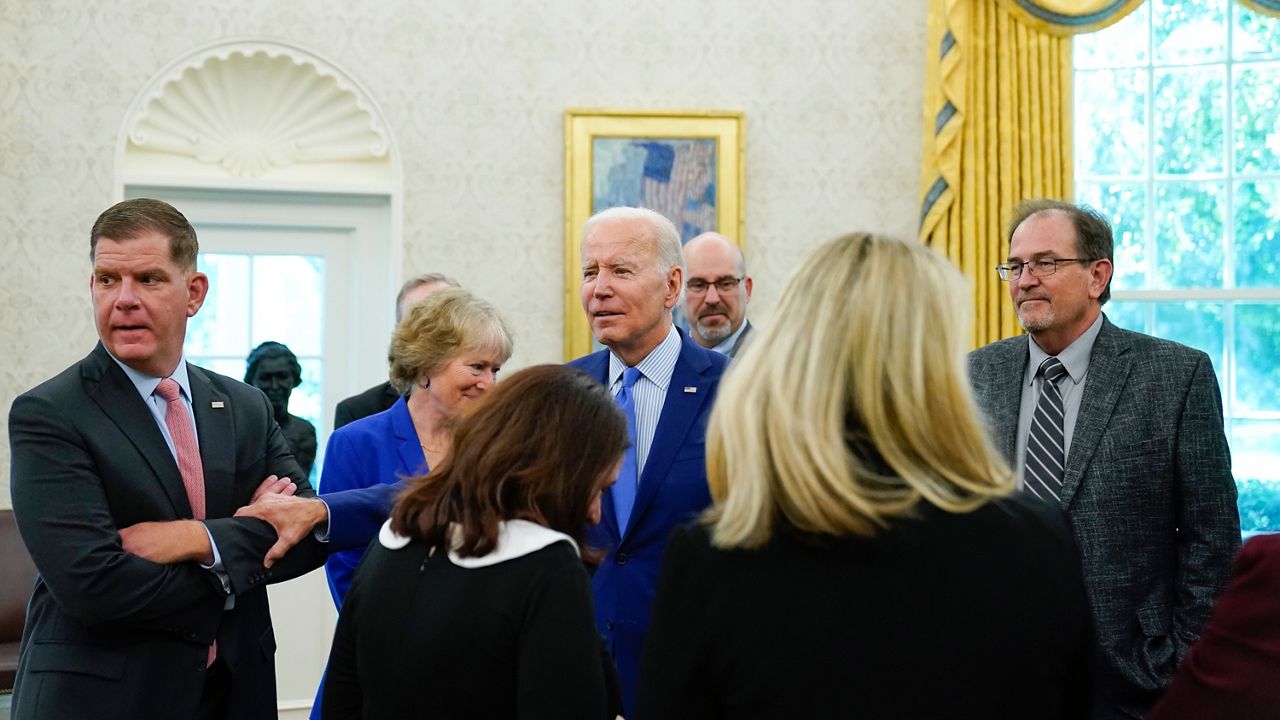 President Joe Biden with Secretary of Labor Marty Walsh, left, speaks in the Oval Office of the White House, Thursday, Sept. 15, 2022, in Washington. (AP Photo/Andrew Harnik)