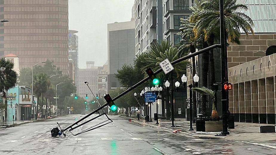 A stoplight pole at Livingston Street, blown down by Hurricane Ian winds, rests on Orange Avenue in Downtown Orlando. (Willie J. Allen Jr./Orlando Sentinel via AP)