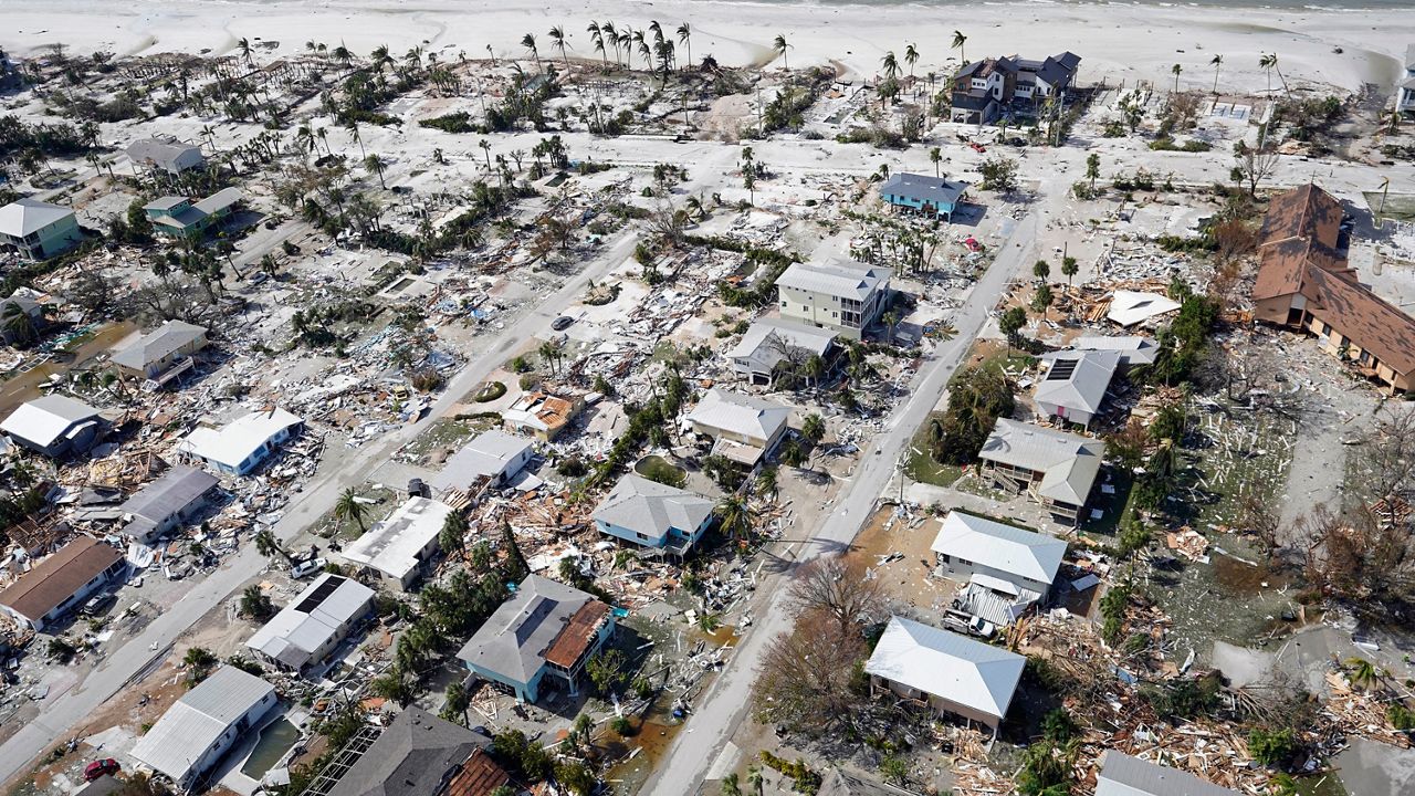 This aerial photo shows damaged homes and debris in the aftermath of Hurricane Ian, Thursday, Sept. 29, 2022, in Fort Myers, Fla. (AP Photo/Wilfredo Lee)