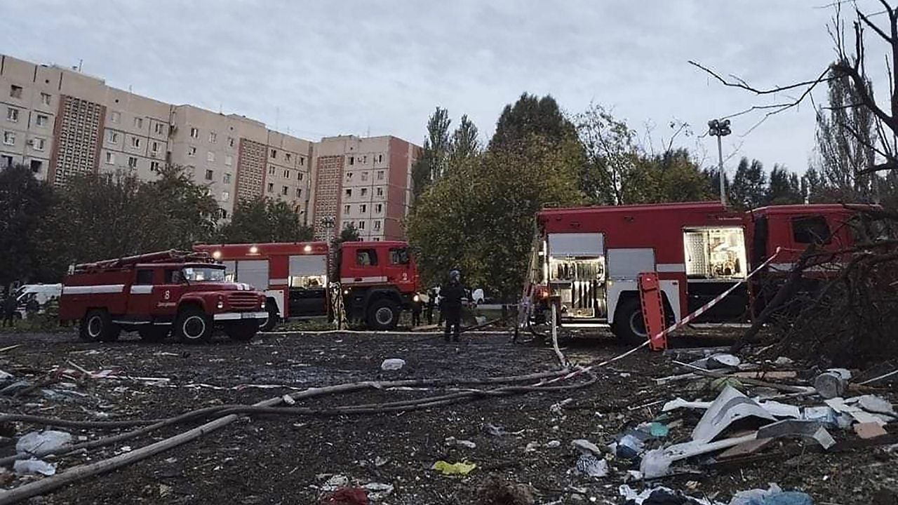 In this photo provided by the Ukrainian Emergency Service, rescuers work at the scene of damages after shelling in Zaporizhzhia, Ukraine, Sunday, Oct. 9, 2022. (Ukrainian Emergency Service via AP)