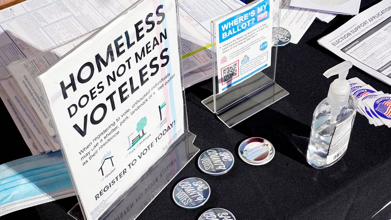 Voter information is displayed at Loaves and Fishes, a nonprofit facility for the homeless in Sacramento, Calif., on Thursday, Oct. 13, 2022. (AP Photo/Rich Pedroncelli)