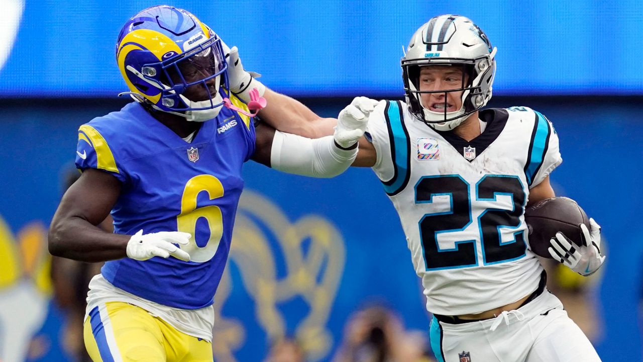 Carolina Panthers running back Christian McCaffrey (22) stiff-arms Los Angeles Rams cornerback Derion Kendrick (6) during the first half of an NFL football game Sunday, Oct. 16, 2022, in Inglewood, Calif. (AP Photo/Ashley Landis)