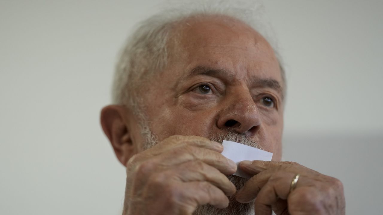 Luiz Inácio Lula da Silva kisses his ticket after voting in a runoff presidential election in Sao Paulo, Brazil, Sunday, Oct. 30, 2022. (AP Photo/Andre Penner)