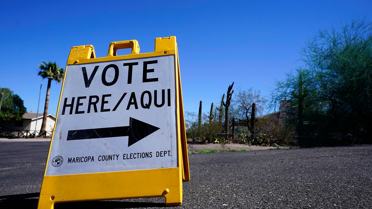 A sign marks the entrance to a voting precinct on the first day of early voting in the general election in Phoenix, Oct. 12, 2022. (AP Photo/Ross D. Franklin, File)