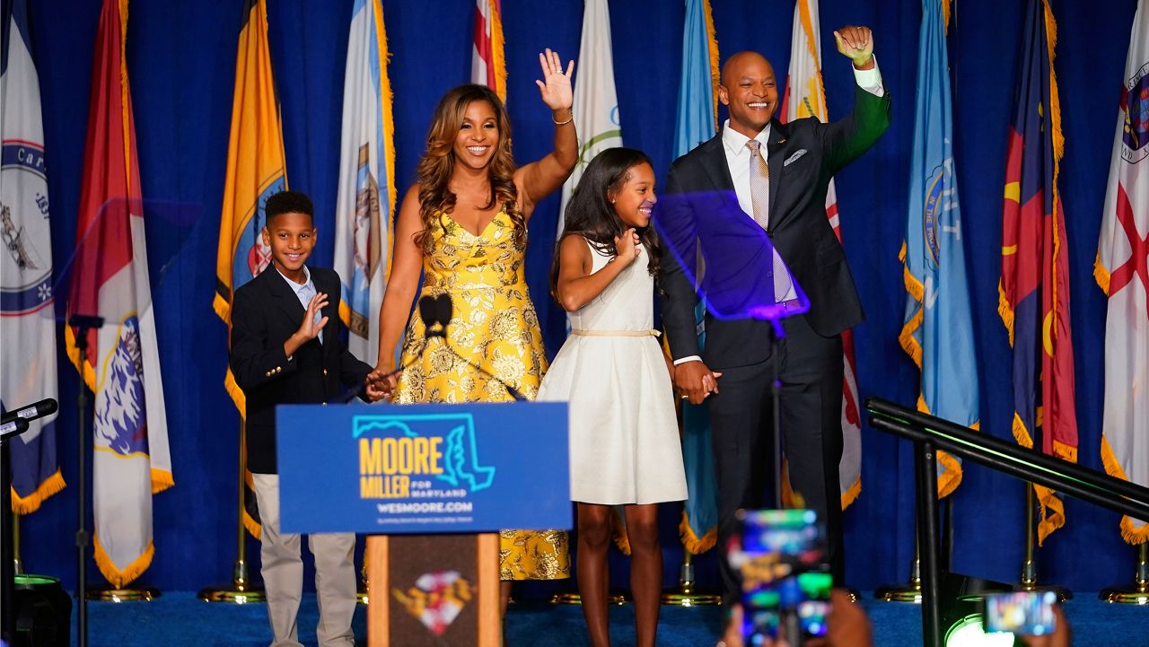 Democrat Wes Moore, right, stands on stage with his wife, Dawn, second from left, their son, Jamie, left, and their daughter, Mia, before speaking to supporters during an election night gathering after he was declared the winner of the Maryland gubernatorial race, Tuesday, Nov. 8, 2022, in Baltimore. (AP Photo/Julio Cortez)