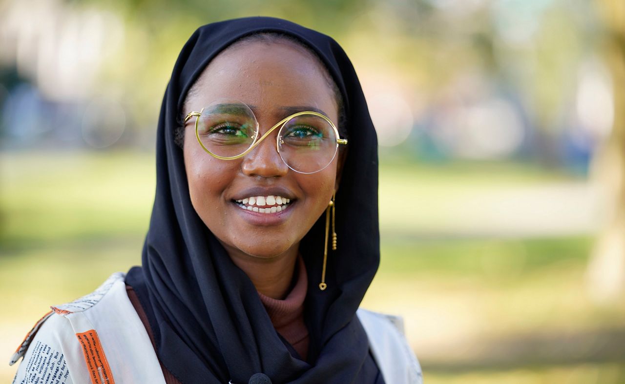 FILE - Mana Abdi, 26, speaks with a reporter in this Oct. 6, 2022 file photo in Lewiston, Maine. Abdi is one of two Somali women elected to the Maine House. (AP Photo/Robert F. Bukaty, file)