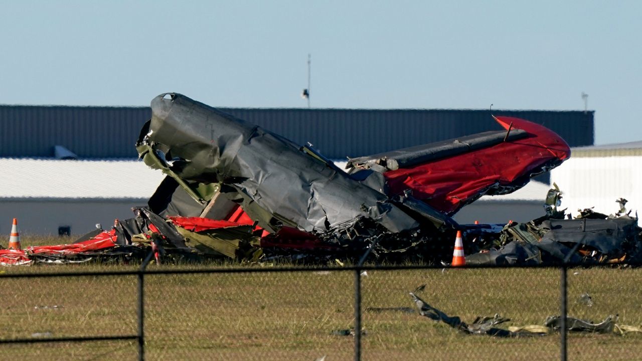 Debris from two planes that crashed during an airshow at Dallas Executive Airport are shown in Dallas on Saturday, Nov. 12, 2022. (AP Photo/LM Otero)