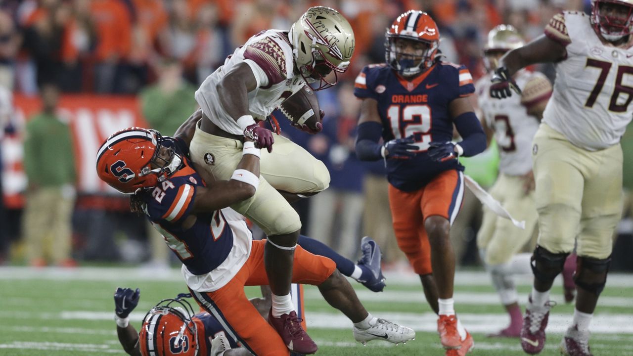 Syracuse defensive back Jeremiah Wilson (24) tackles Florida State running back Trey Benson (3) during the first half of an NCAA college football game Saturday, Nov. 12, 2022, in Syracuse, N.Y. (AP Photo/Joshua Bessex)