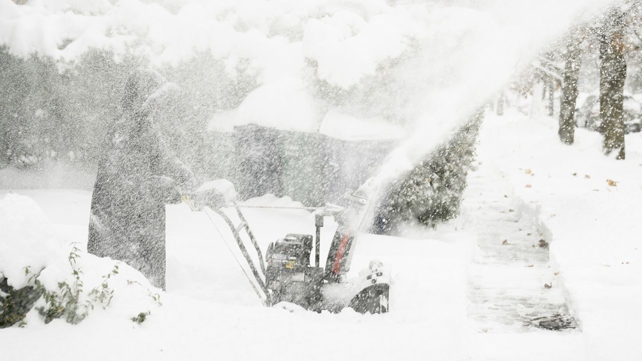 Star Haynes clears snow from her driveway with a snowblower, Saturday, Nov. 19, 2022 in Buffalo, N.Y. Residents of northern New York state are digging out from a dangerous lake-effect snowstorm that had dropped nearly 6 feet of snow in some areas and caused three deaths. The Buffalo metro area was hit hard, with some areas south of the city receiving more than 5 feet by early Saturday. (Libby March /The Buffalo News via AP)