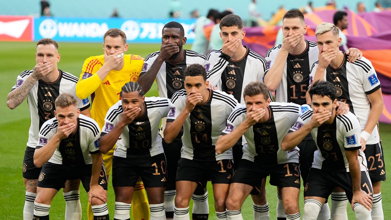 German's team covers their mouth during the team photo prior to the World Cup group E soccer match between Germany and Japan, at the Khalifa International Stadium in Doha, Qatar, Wednesday, Nov. 23, 2022. (AP Photo/Matthias Schrader)