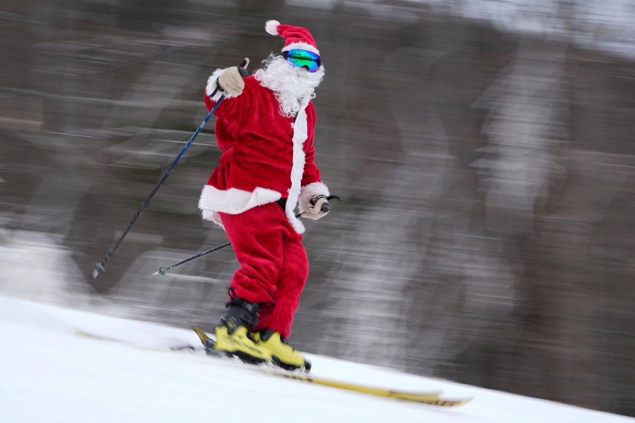 A skier dressed as Santa Claus skis for charity at the Sunday River Ski Resort on Sunday in Newry. (AP Photo/Robert F. Bukaty)