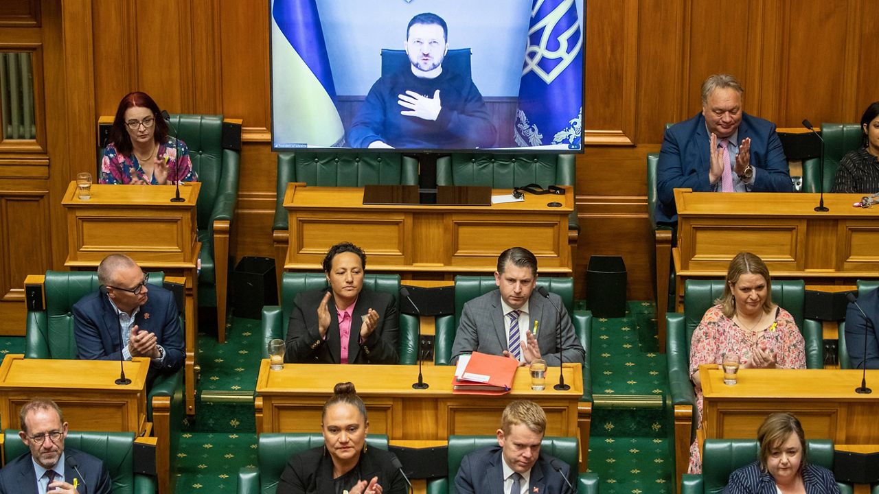 Ukrainian President Volodymyr Zelenskyy appears via video during his address to the New Zealand Parliament in Wellington Wednesday, Dec. 14, 2022. Zelenskyy urges New Zealand to take a leading role in focusing on the environmental destruction his country is suffering as a result of Russia's invasion. (Mark Mitchell/New Zealand Herald via AP)