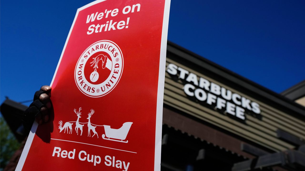 FILE - Starbucks employees strike outside their store in Mesa, Ariz., Nov. 17, 2022. Starbucks workers around the U.S. are planning a three-day strike starting Friday, Dec. 16, as part of their effort to unionize the coffee chain's stores. (AP Photo/Matt York, File)