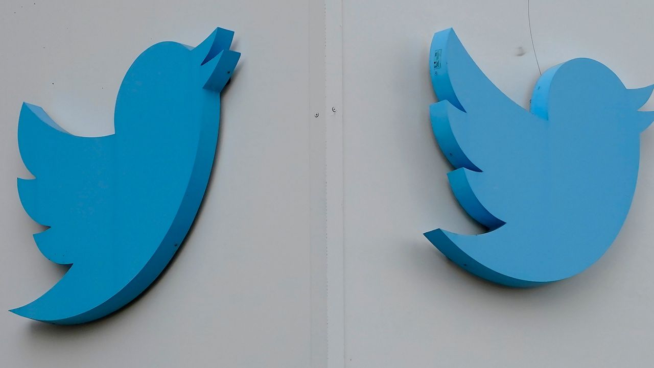 Twitter logos hang outside the company's offices in San Francisco, Monday, Dec. 19, 2022. (AP Photo/Jeff Chiu)