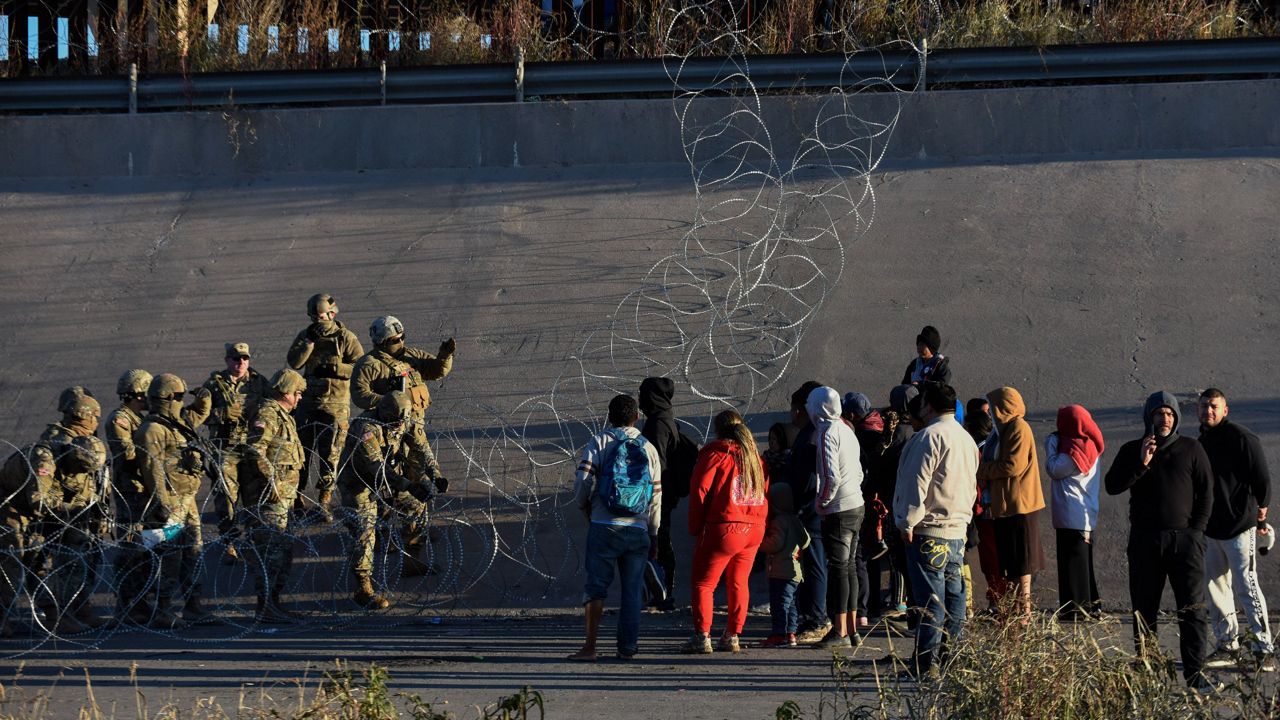 U.S. military stop migrants from crossing into El Paso, Texas, seen from Ciudad Juarez, Mexico, Tuesday, Dec. 20, 2022. (AP Photo/Christian Chavez)
