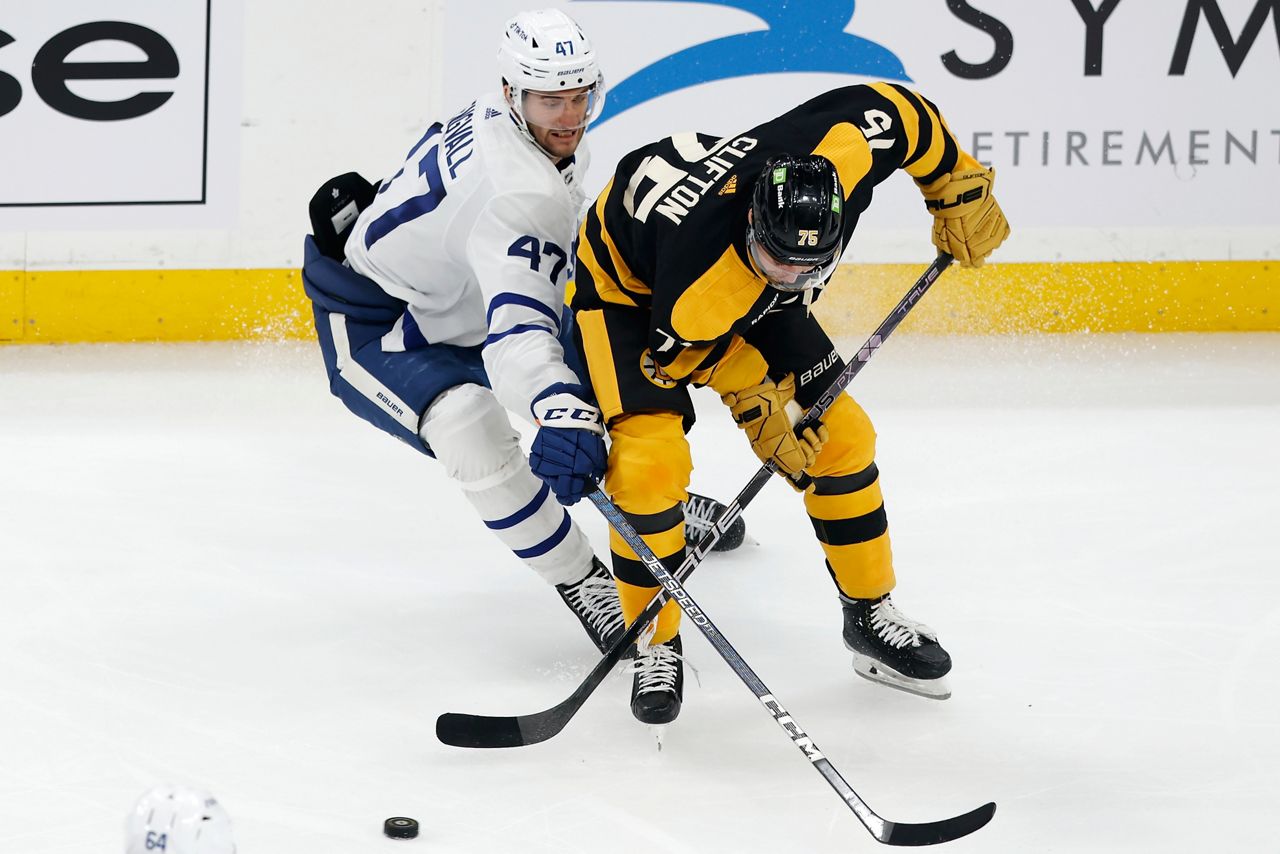 Toronto Maple Leafs' Pierre Engvall (47) and Boston Bruins' Connor Clifton (75) battle for the puck during the second period of an NHL hockey game, Saturday, Jan. 14 2023, in Boston. (AP Photo/Michael Dwyer)