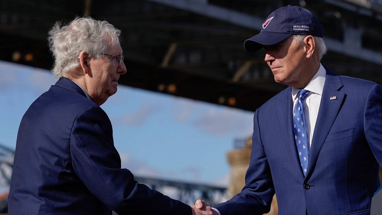 President Joe Biden shakes hands with Senate Minority Leader Mitch McConnell of Ky., after speaking about his infrastructure agenda under the Clay Wade Bailey Bridge, Jan. 4, 2023, in Covington, Ky. (AP Photo/Patrick Semansky)