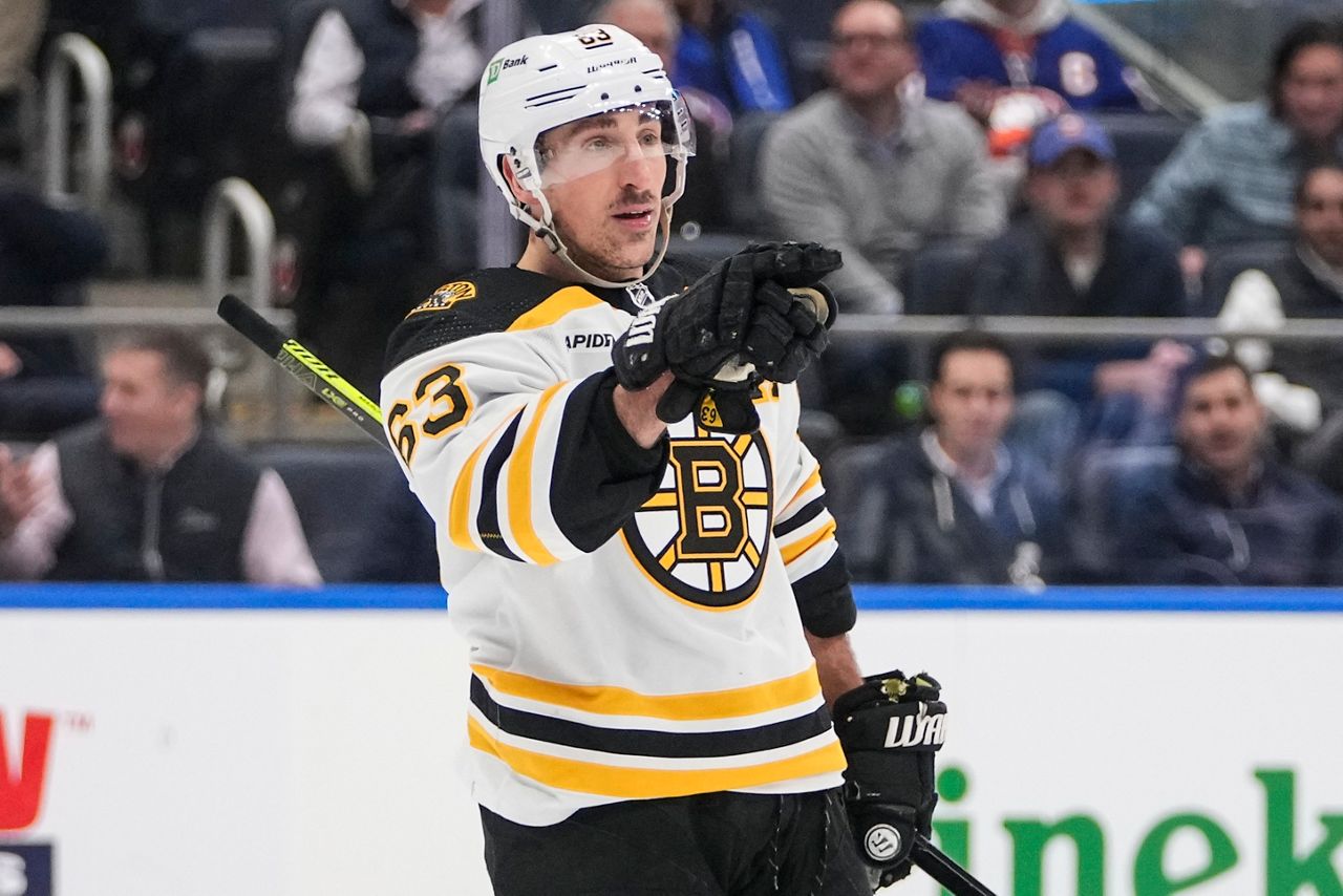 Boston Bruins' Brad Marchand (63) gestures to a teammate after scoring a goal during the third period of an NHL hockey game against the New York Islanders Wednesday, Jan. 18, 2023, in Elmont, N.Y. The Bruins won 4-1. (AP Photo/Frank Franklin II)