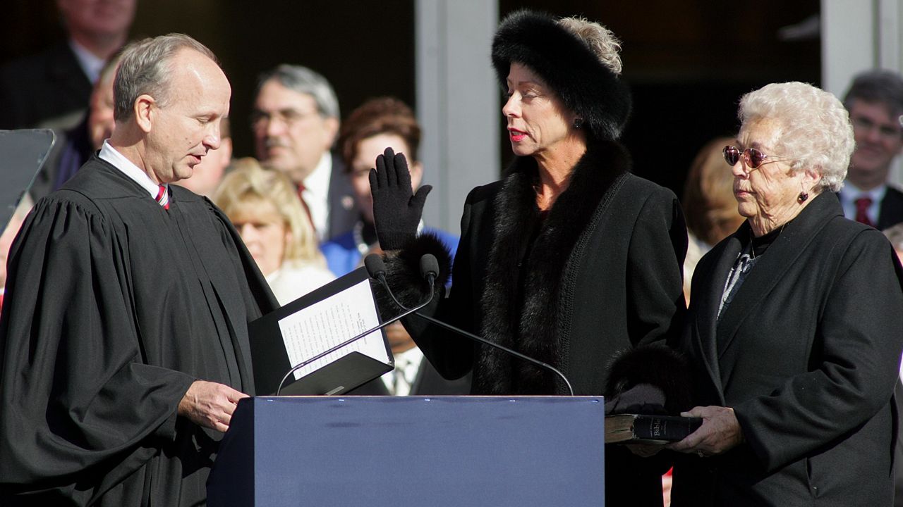 N.C. State Auditor Beth Wood, center, is sworn into office by Supreme Court Justice Paul Newby as her mother, Betty Wood, looks on Jan. 10, 2009, at the State Library building in Raleigh, N.C. (AP Photo/Jim R. Bounds, File)