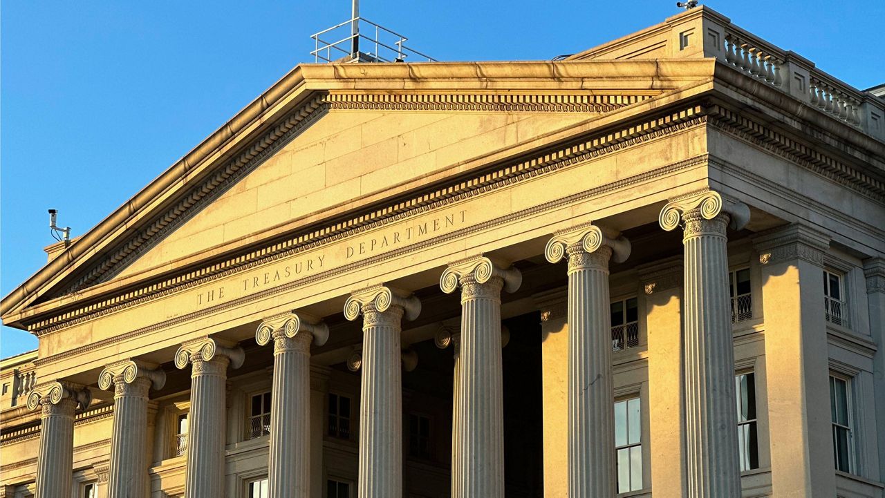 The Treasury Department is seen near sunset in Washington, Jan. 18, 2023. The national debt is at the core of a dispute about how to raise the government's legal borrowing authority, which could come to a head this summer if the government runs out of accounting maneuvers to keep paying its bills. (AP Photo/Jon Elswick)