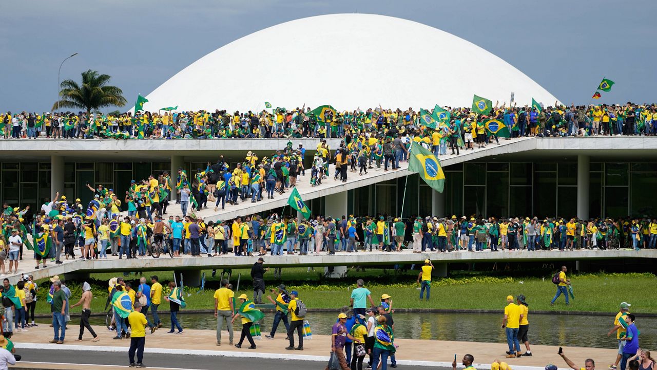 Protesters, supporters of Brazil's former President Jair Bolsonaro, storm the the National Congress building in Brasilia, Brazil, Jan. 8, 2023. Brazil’s federal police searched the home of a nephew of Bolsonaro on Friday, Jan. 27, 2023, in connection with the Jan. 8 storming of government buildings in the capital by far-right protesters. (AP Photo/Eraldo Peres)