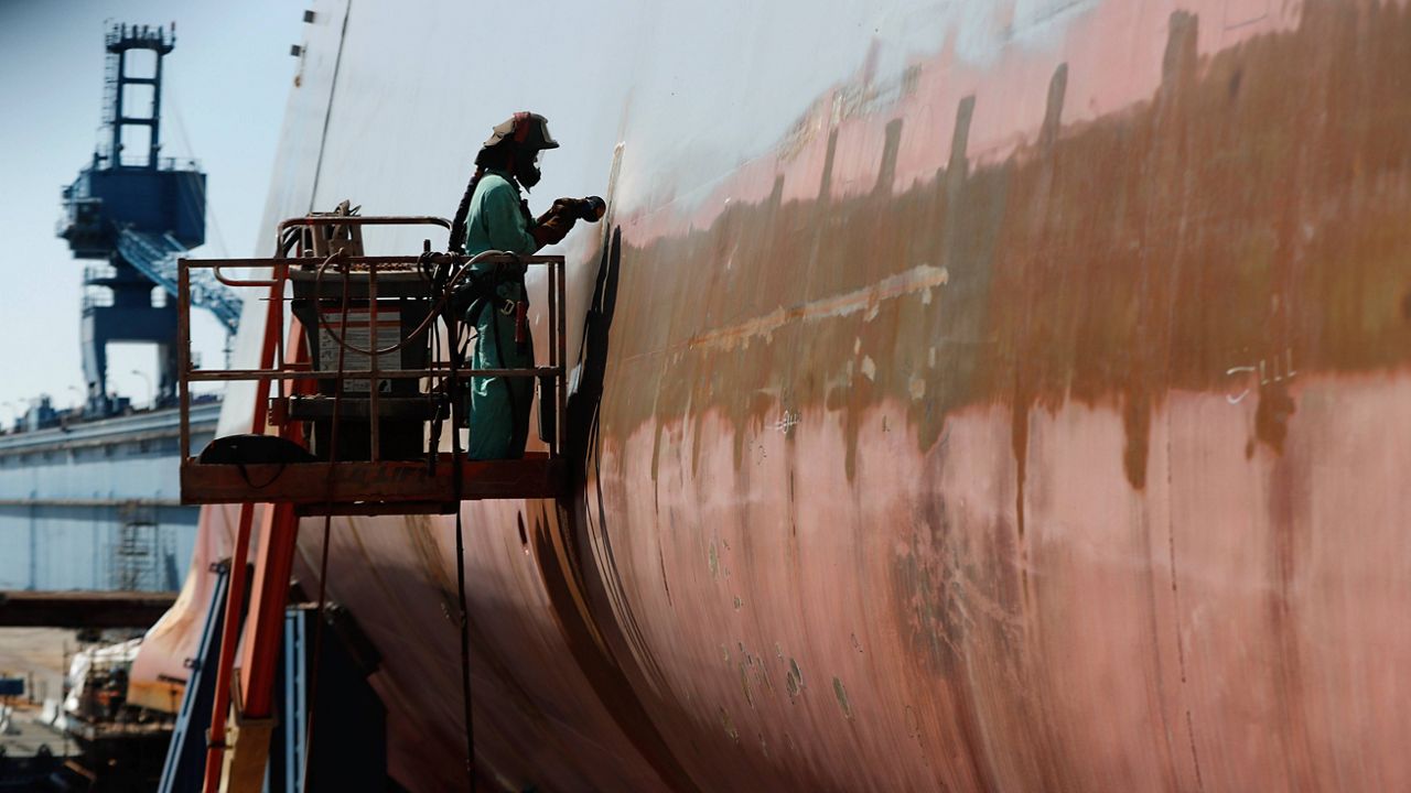 Welder Neal Larsen works on the hull of a Zumwalt-class destroyer Aug. 29, 2018, being built in the shipyard at Bath Iron Works in Bath, Maine. (AP Photo/Robert F. Bukaty)