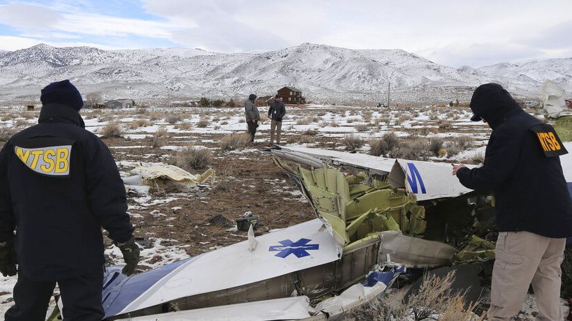 This photo provided by The National Transportation Safety Board shows NTSB investigators on Sunday, Feb. 26, 2023, at the crash site in Dayton, Nev. documenting the wreckage of a Pilatus PC-12 airplane a medical air transport flight operated by Guardian Flight that crashed on Friday, Feb. 24, while enroute from Reno, Nevada, to Salt Lake City. (NTSB via AP)