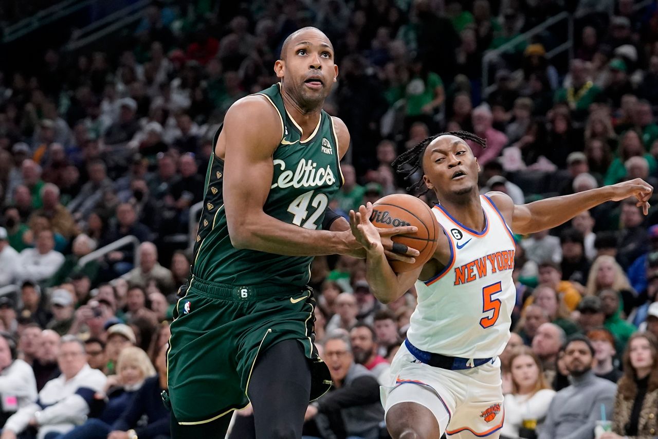 Boston Celtics center Al Horford (42) drives toward the basket as New York Knicks guard Immanuel Quickley (5) defends on Sunday, March 5, in Boston. (AP Photo/Steven Senne)