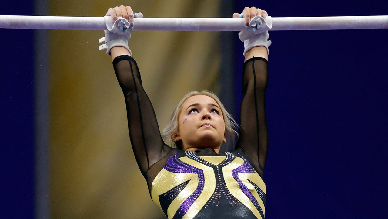 LSU gymnast Olivia Dunne competes during an NCAA gymnastics meet against Arkansas on Friday, Jan. 8, 2021 in Baton Rouge, La. LSU gymnast Olivia Dunne's endorsement of an artificial intelligence essay-writing product is raising questions about whether college athletic programs should provide clearer ethical guidelines for athletes earning money from name, image and likeness contracts.  (AP Photo/Tyler Kaufman)