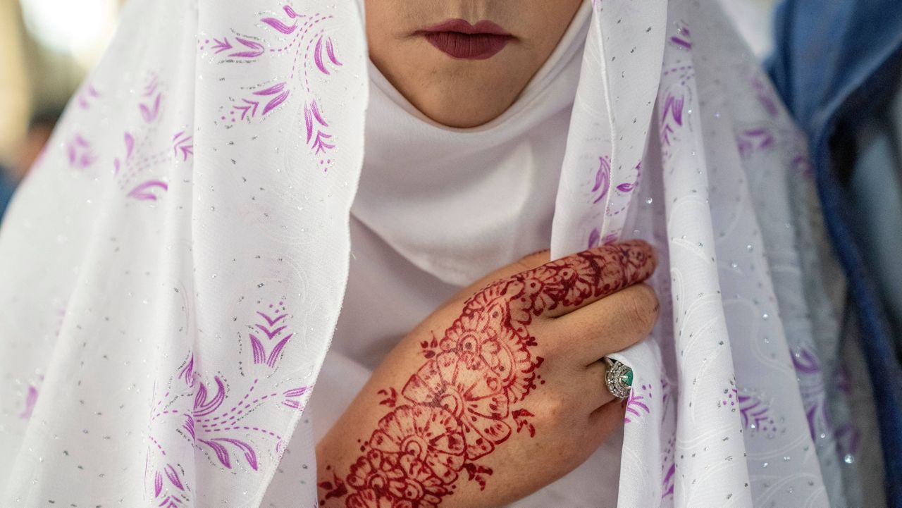 An Afghan bride attends a mass wedding ceremony during the International Women's Day, in Kabul, Afghanistan, Wednesday, March 8, 2023. (AP Photo/Ebrahim Noroozi)