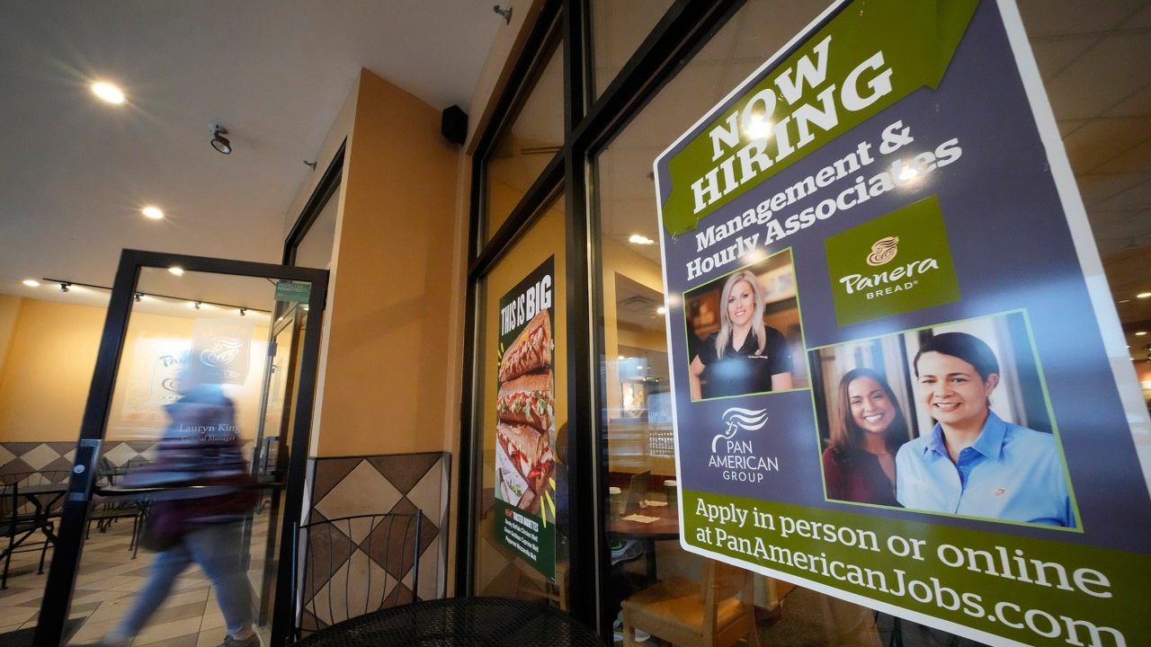 A hiring sign is displayed in the window of a Panera Bread store. (AP Photo/Gene J. Puskar, File)