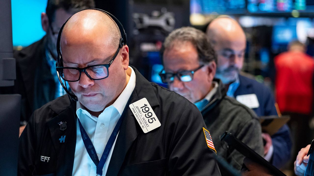 Traders work on the floor at the New York Stock Exchange in New York, Monday, March 13, 2023. (AP Photo/Craig Ruttle)