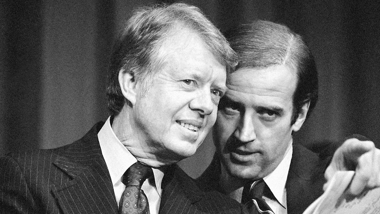 In this Feb. 20, 1978, file photo, President Jimmy Carter listens to Sen. Joseph R. Biden, D-Del., as they wait to speak at fund raising reception at Padua Academy in Wilmington, Del. (AP Photo/Barry Thumma)