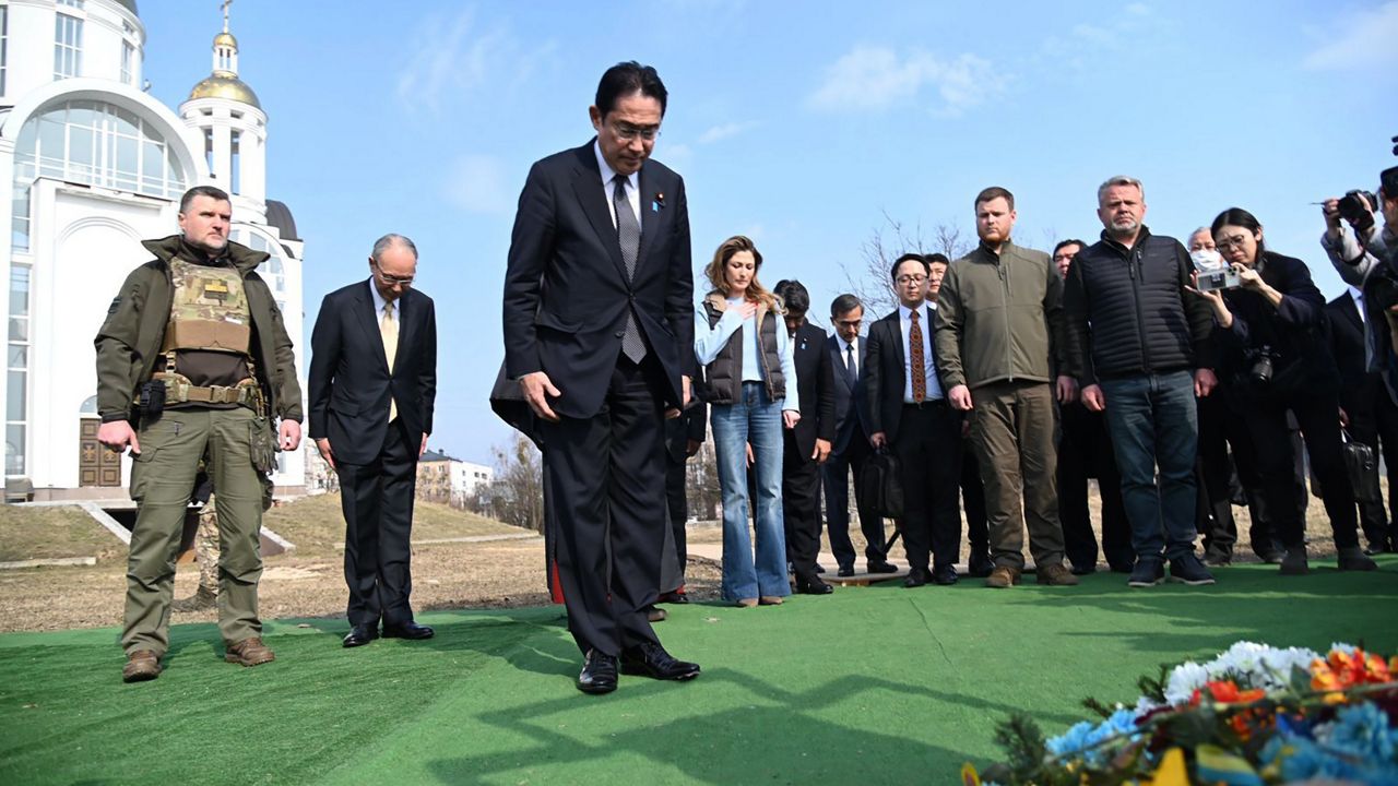 Japanese Prime Minister Fumio Kishida, centre, offers prayers, at a church in Bucha, a town outside Kyiv that became a symbol of Russian atrocities against civilians, in Ukraine, Tuesday, March 21, 2023. (Ukrainian Foreign Ministry Press Office via AP)