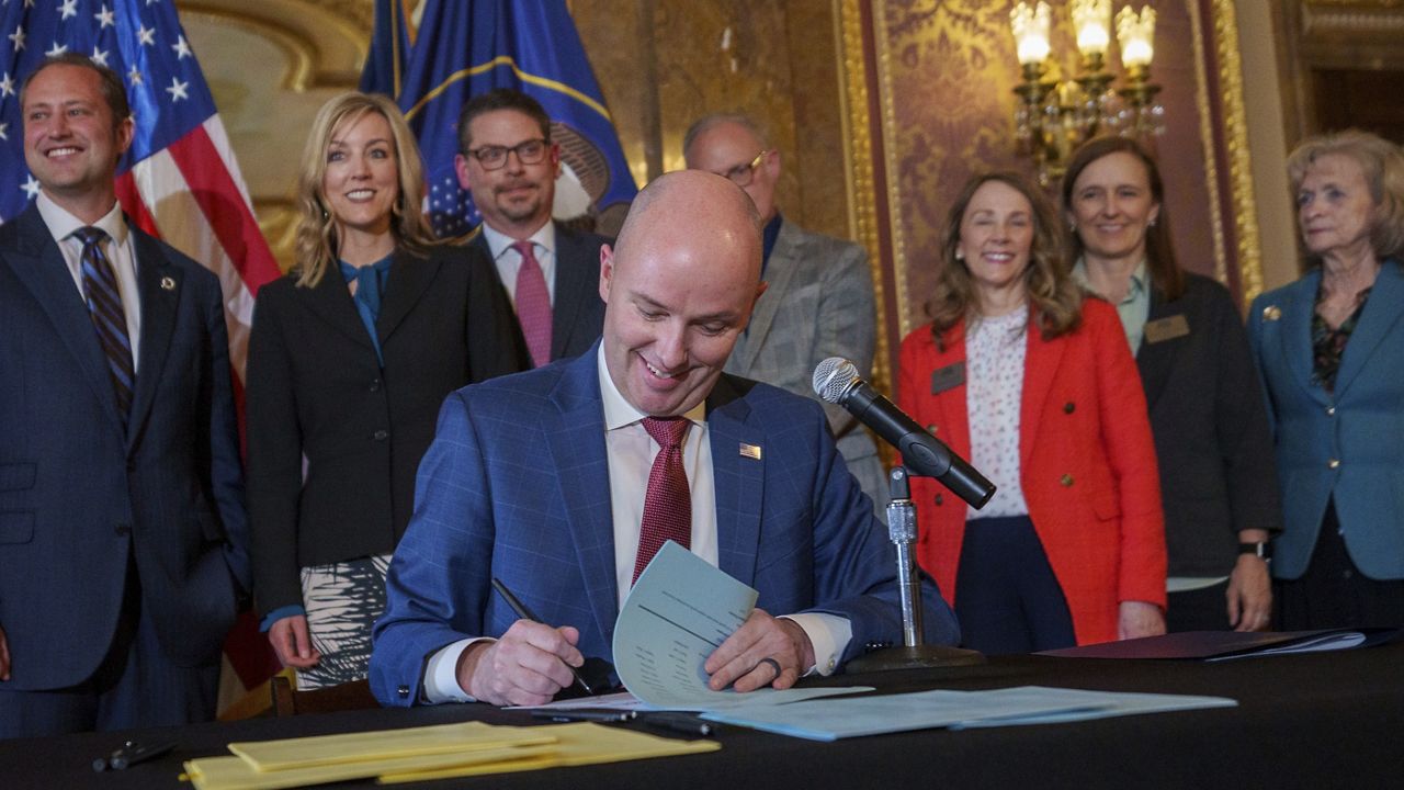 Gov. Spencer Cox signs two social media regulation bills Thursday during a ceremony at the Capitol building in Salt Lake City. (Trent Nelson/The Salt Lake Tribune via AP)