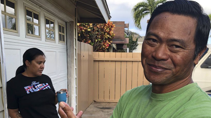 Tedorian Gallano, right, and his wife Nicole Gallano, stand outside their home in Waianae, Hawaii, on Feb. 26, 2023. Hawaii's housing shortage has set off a population decline and grown so acute it has sparked widespread concern many of Hawaii's children won't be able to afford living in their homeland as adults. (AP Photo/Audrey McAvoy)