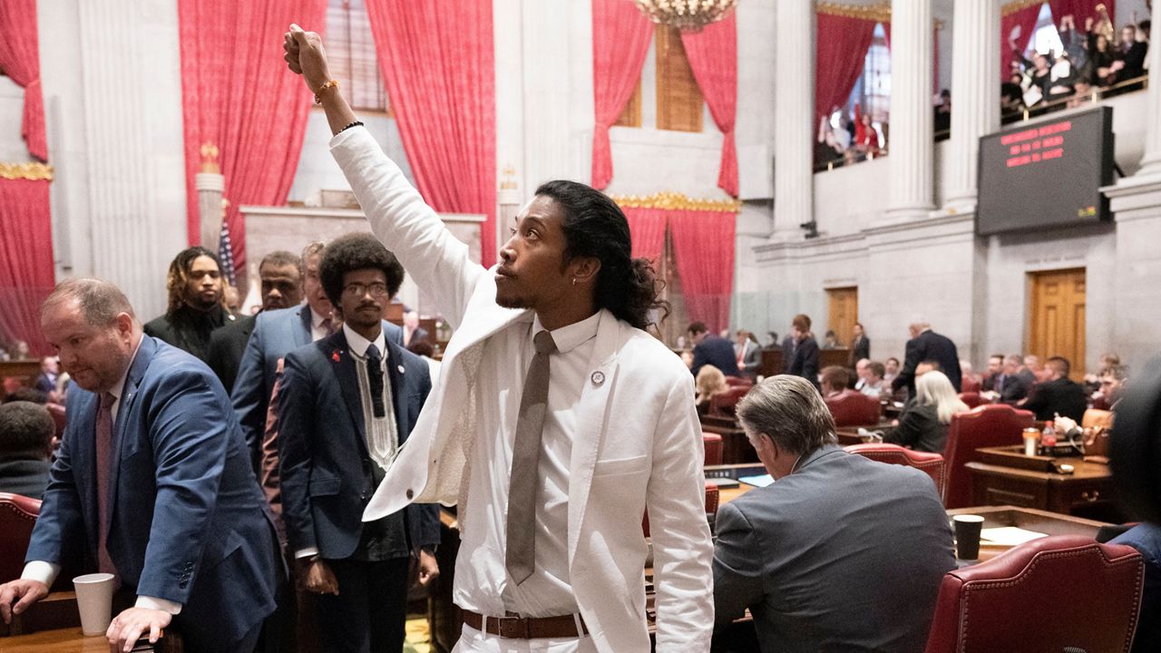 Former Rep. Justin Jones, D-Nashville, raises his fist on the floor of the House chamber as he walks to his desk to collect his belongings after being expelled from the legislature on Thursday, April 6, 2023, in Nashville, Tenn. (AP Photo/George Walker IV)
