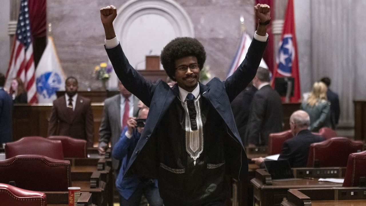 Former Rep. Justin Pearson, D-Memphis, raises his fists as he leaves the House chamber after he is expelled from the legislature Thursday, April 6, 2023, in Nashville, Tenn. (AP Photo/George Walker IV)