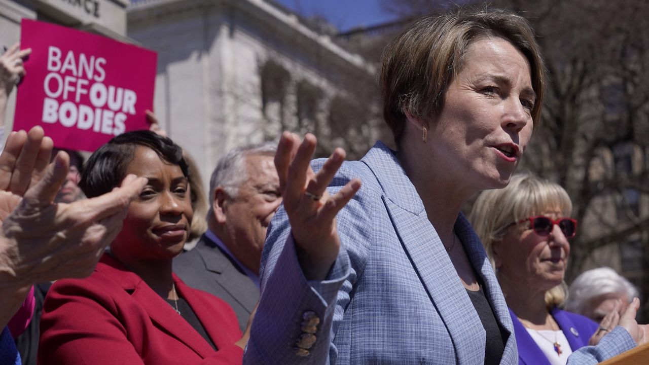 Gov. Maura Healey, front right, faces reporters as Massachusetts Attorney General Andrea Campbell, left, looks on, Monday, April 10, 2023, during a news conference in front of the Statehouse, in Boston. (AP Photo/Steven Senne)