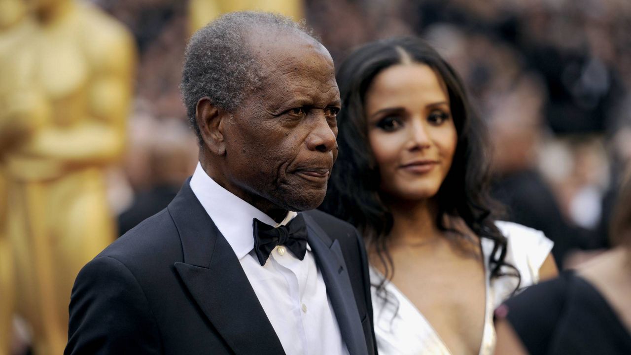 Sidney Poitier, left, and Sydney Tamiia Poitier arrive at the Oscars on March 2, 2014, at the Dolby Theatre in Los Angeles. (Photo by Chris Pizzello/Invision/AP)
