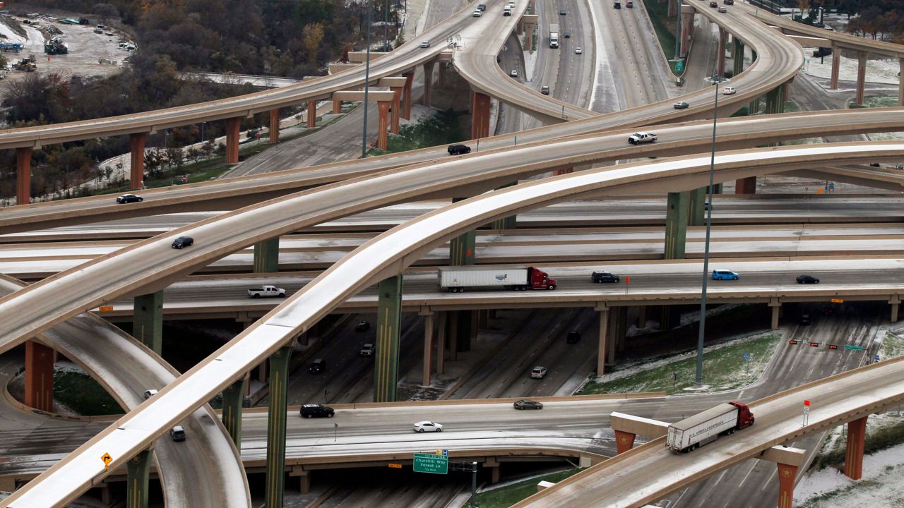 The Hi-Five interchange where LBJ Freeway and Hwy 75 connect is shown with vehicles trying to navigate the icy road conditions, Saturday, Dec. 7, 2013, in Dallas. (AP Photo/Tony Gutierrez)