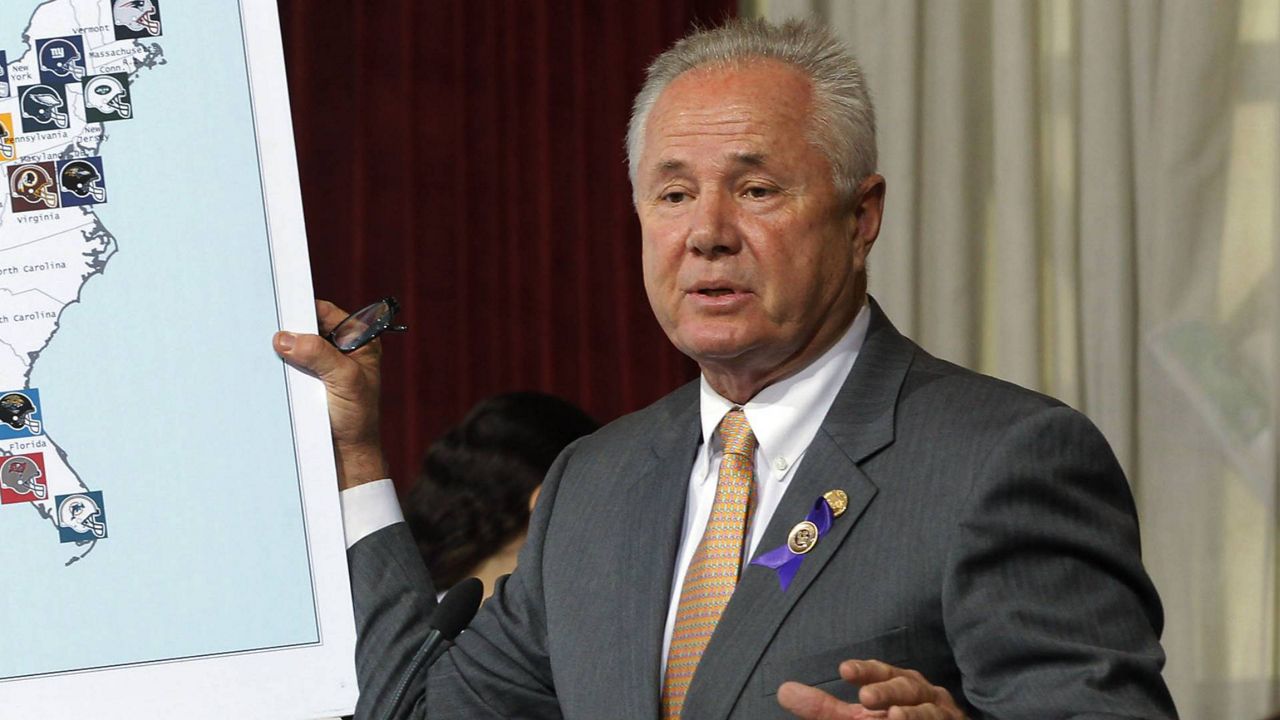 In this Oct. 9, 2013 file photo, Los Angeles City Council member Tom LaBonge displays a visual aid showing locations of NFL football teams at City Hall in Los Angeles. (AP Photo/Nick Ut)