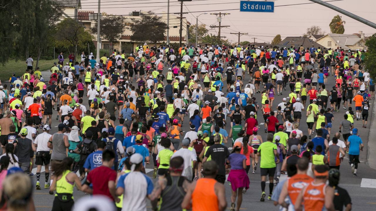 Runners in the 30th Los Angeles Marathon take off from Dodger Stadium in Los Angeles, Sunday, March 15, 2015. (AP Photo/Damian Dovarganes)