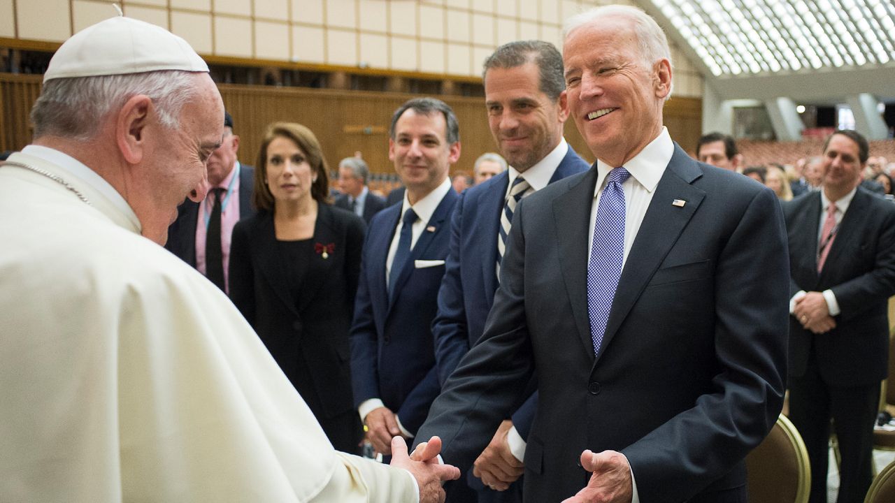 File Photo: Pope Francis shakes hands with then-U.S. vice president Joe Biden as he takes part at a congress on the progress of regenerative medicine and its cultural impact, being held in the Pope Paul VI hall at the Vatican, Friday, April 29, 2016. (L'Osservatore Romano/Pool photo via AP)