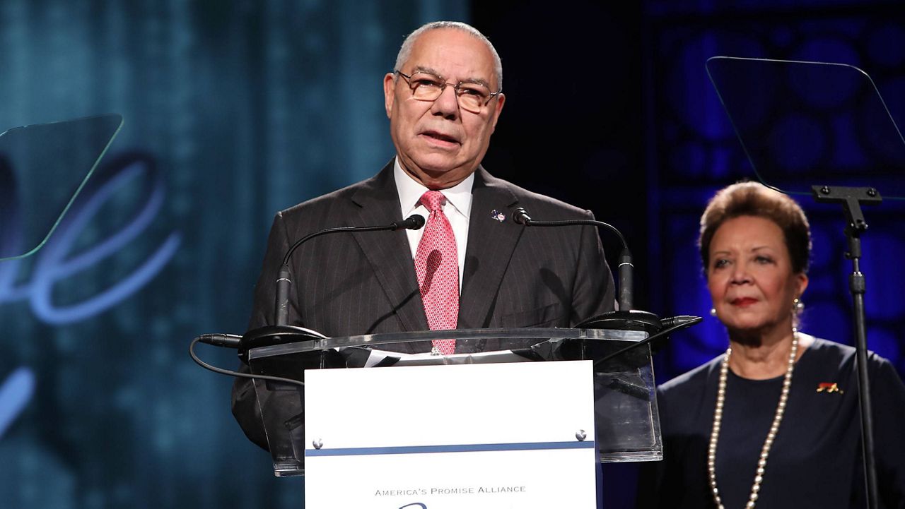 Colin Powell, with his wife, Alma, in the background, speaks at an event in 2017. (Amy Sussman/AP Images for America's Promise Alliance)
