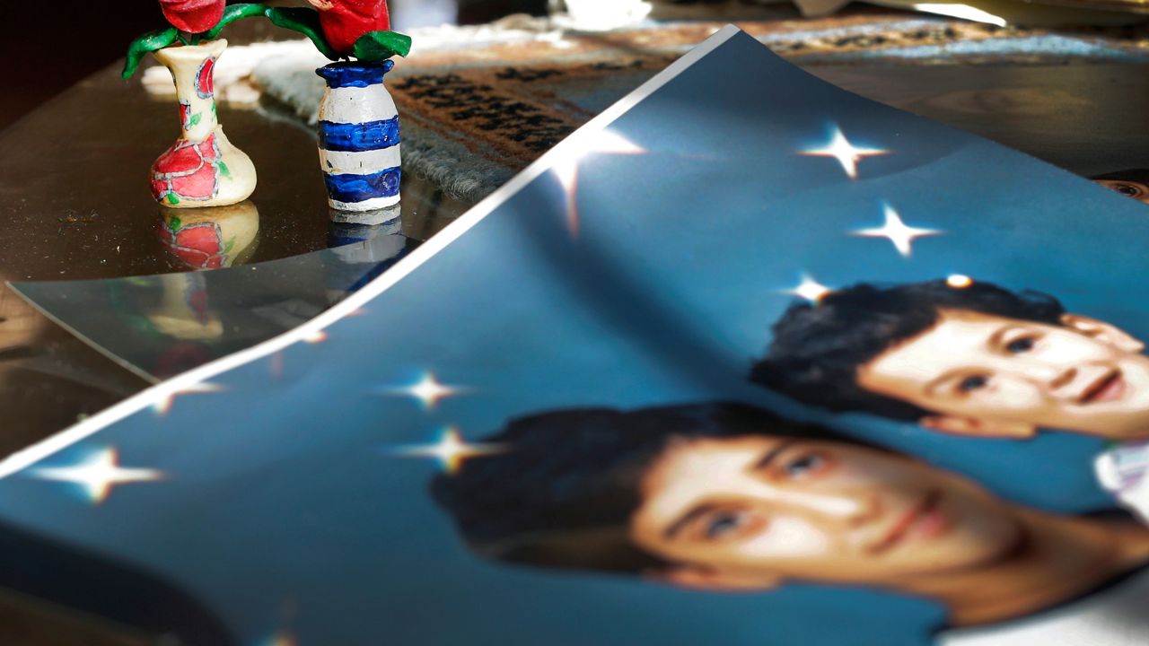 FILE - In this Dec. 10, 2014 file photo, prison artwork created by Adnan Syed sits near family photos in the home of his mother, Shamim Syed, in Baltimore. Adnan Syed, a convicted killer at the center of the first season of the podcast "Serial," is scheduled to appear in court Wednesday, Feb. 3, 2016 as his attorneys argue for a new trial. (AP Photo/Patrick Semansky, File)